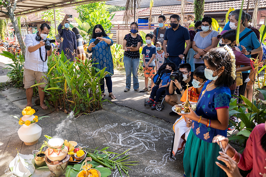 Community coming together to celebrate Pongal and prepare the ritual Pongal dish.